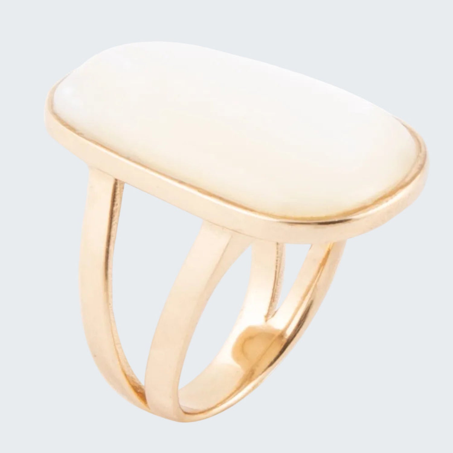 Gold ring with a white stone on a white background