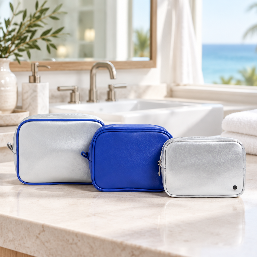 STATE Bags Silver/Cobalt set of three travel pouches on a bathroom counter