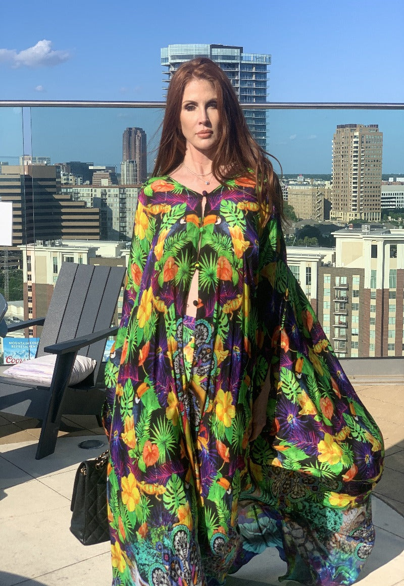 Woman wearing a colorful patterned dress on a rooftop with cityscape in the background