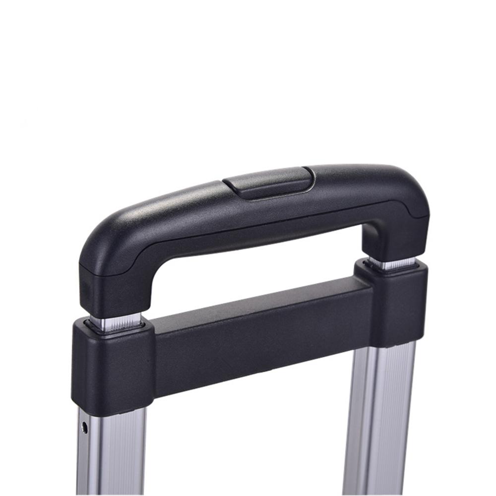 Close-up of a black suitcase handle on a white background