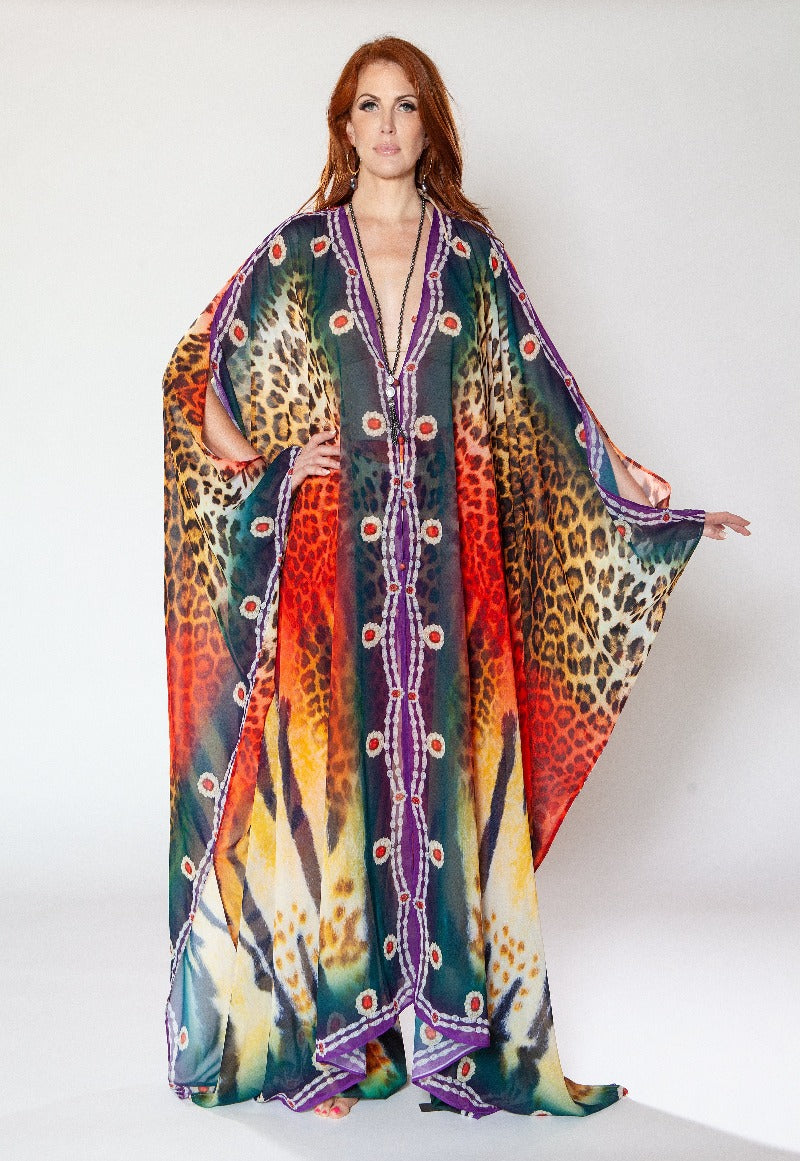 Woman wearing a colorful patterned dress with a white background