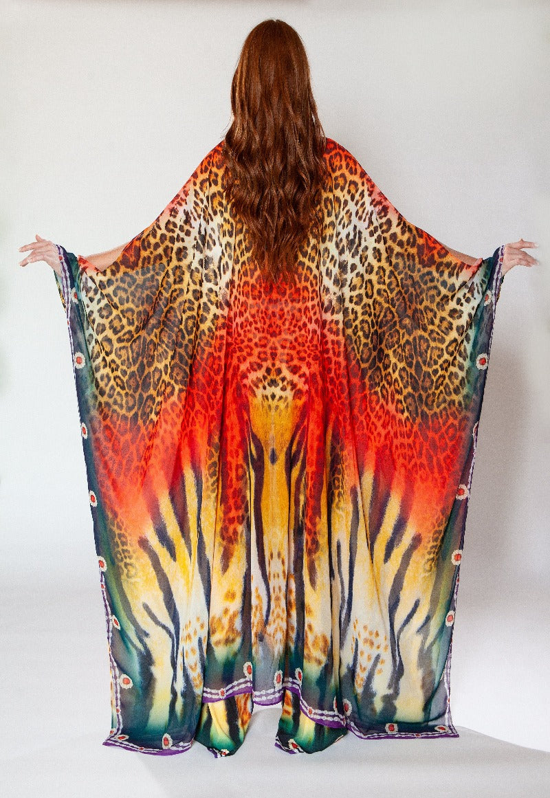 Person wearing a colorful animal print scarf with a white background