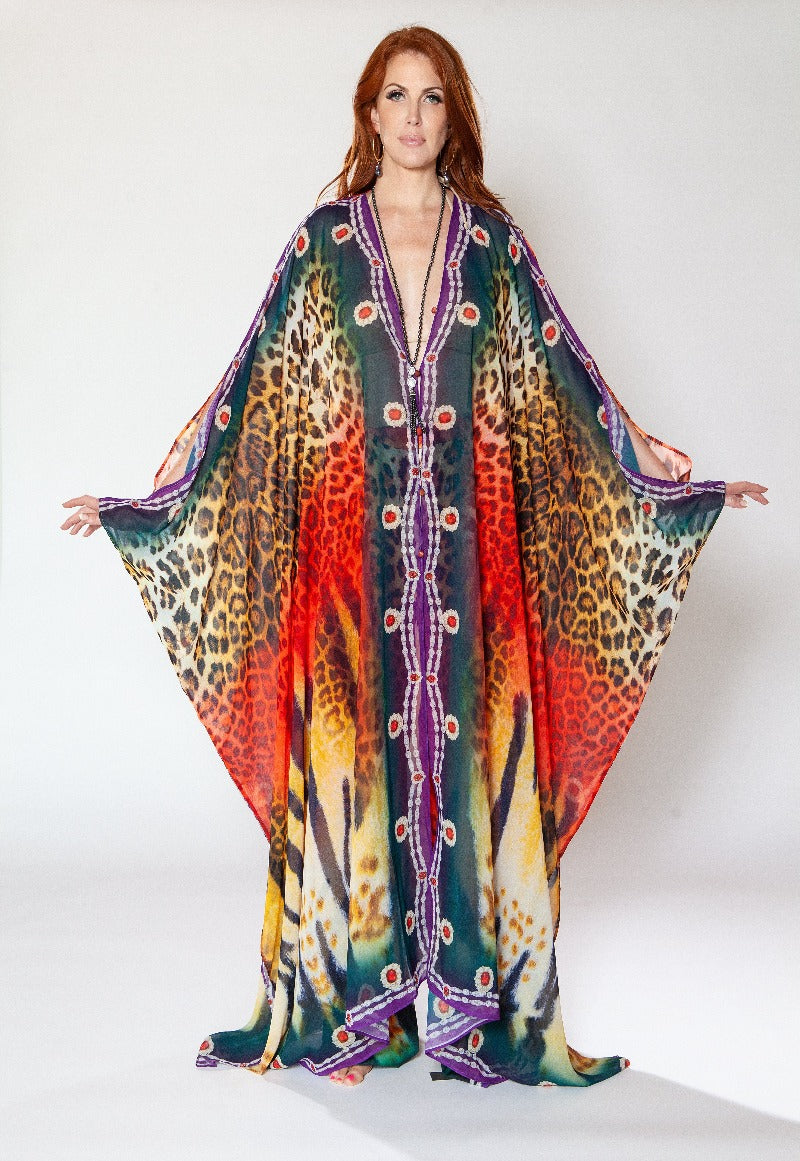 Woman wearing a colorful patterned dress with a white background