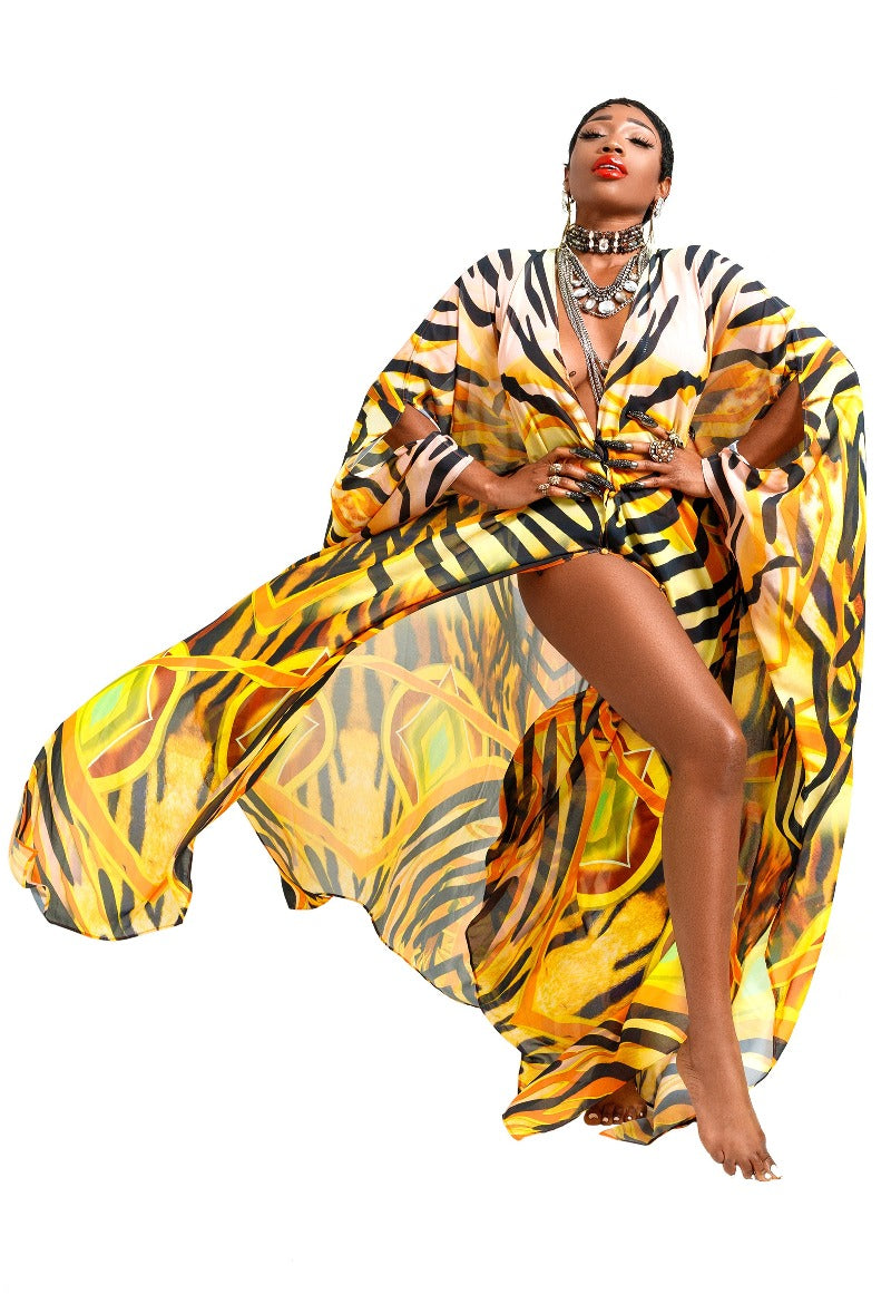 Woman wearing a vibrant, patterned dress with a white background