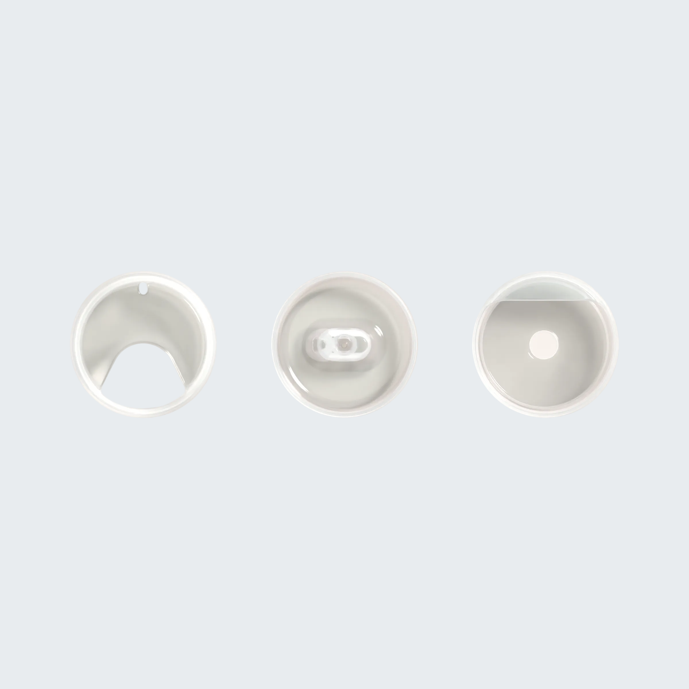Three white ceramic bowls of varying sizes on a light gray background