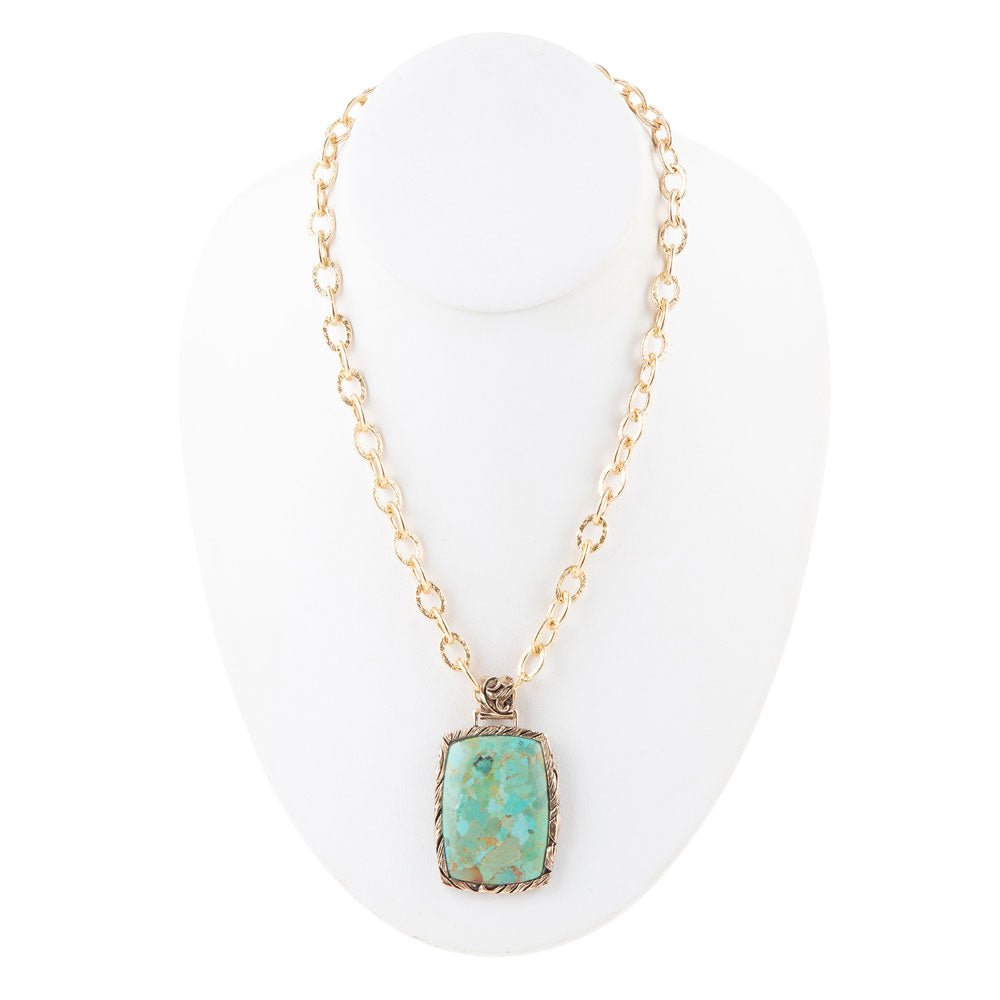 Necklace with a turquoise pendant on a white background