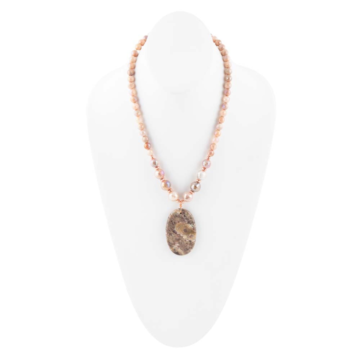 Necklace with a pendant on a white stand