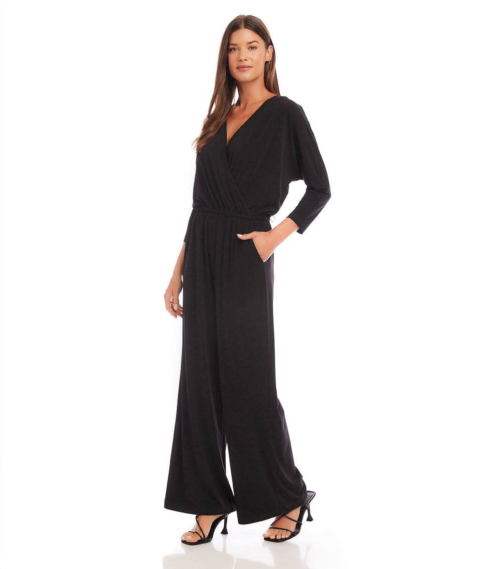 Woman wearing a black jumpsuit on a white background