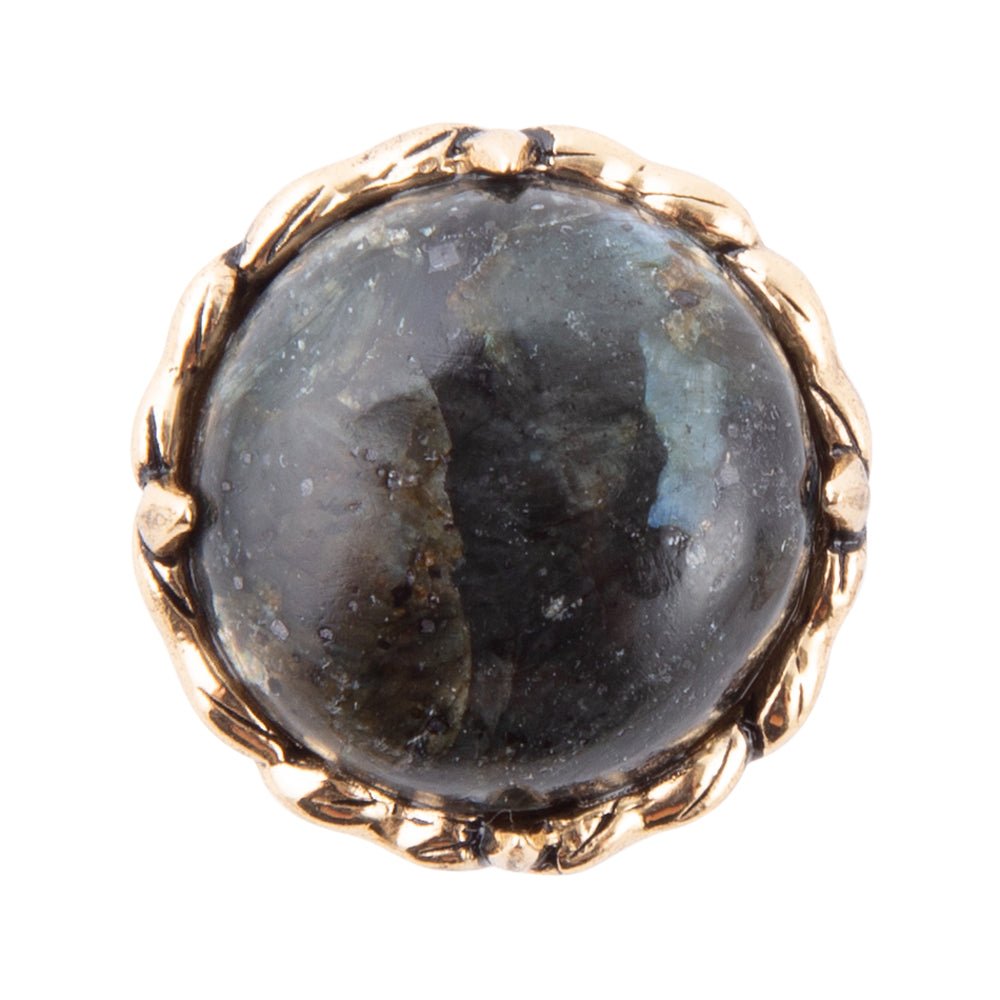 Gold ring with a dark gemstone on a white background
