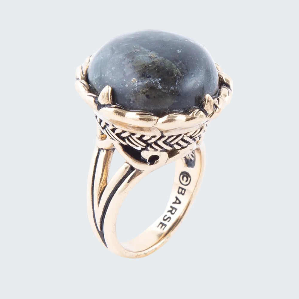 Gold ring with a large blue stone on a white background