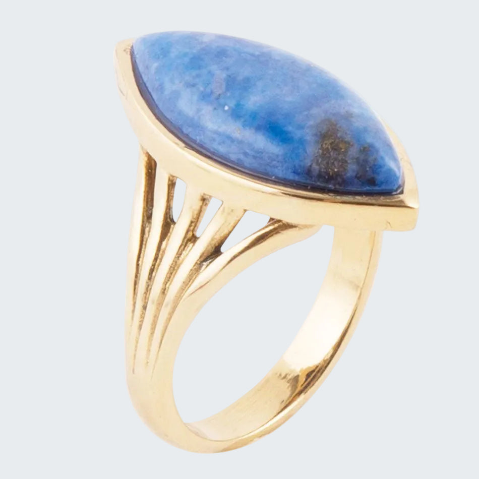Gold ring with a blue stone on a white background