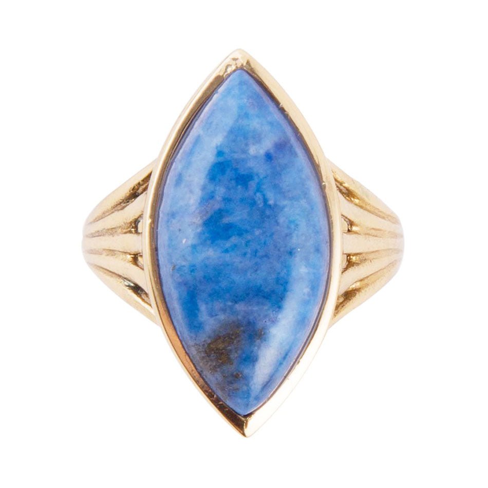 Gold ring with a blue stone on a white background