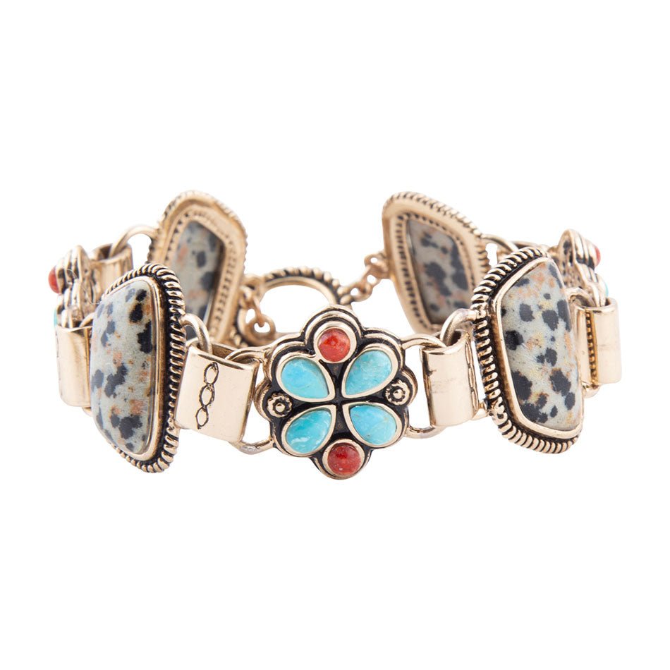 Bracelet with floral design and turquoise stone on a white background