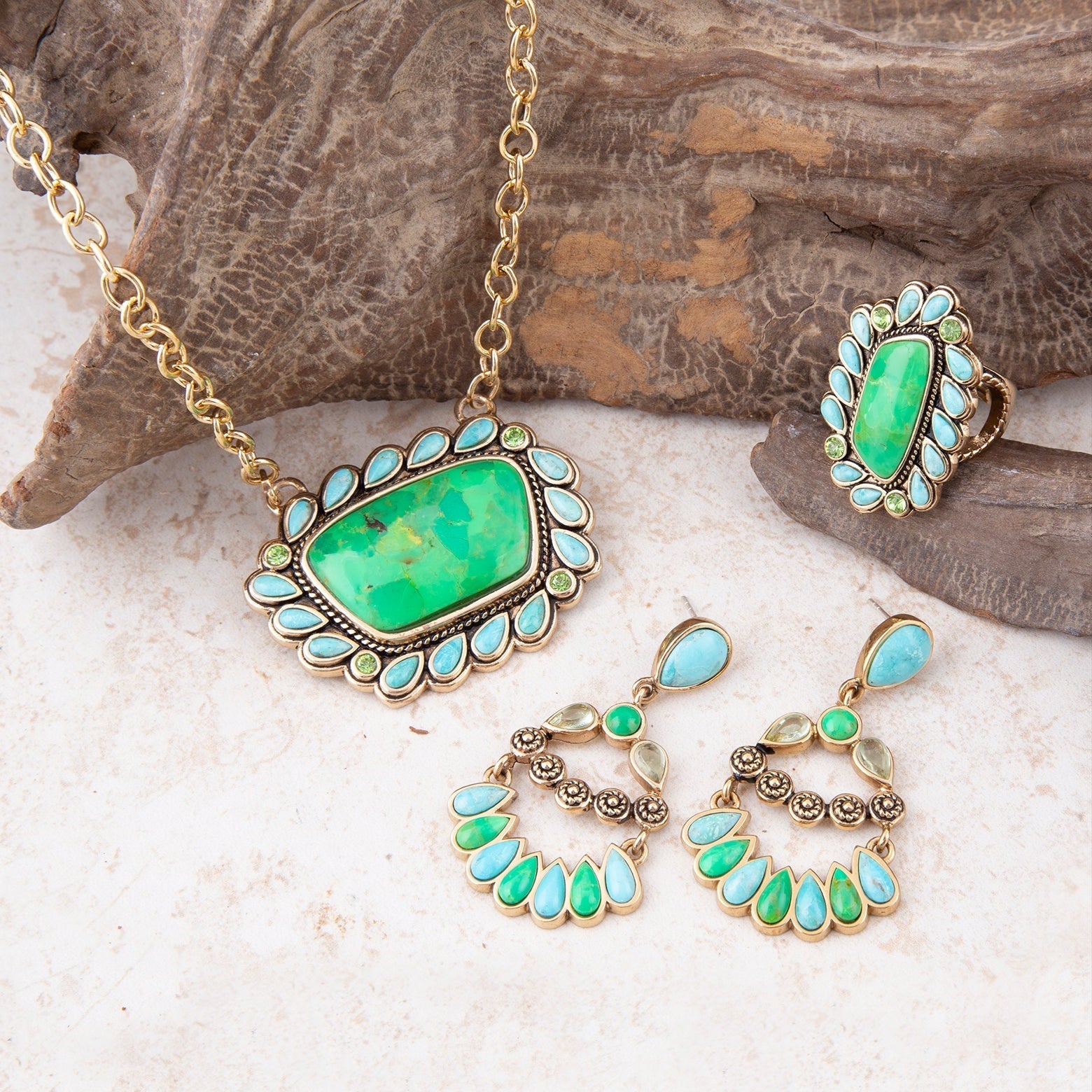 Jewelry set with green stones on a natural stone background
