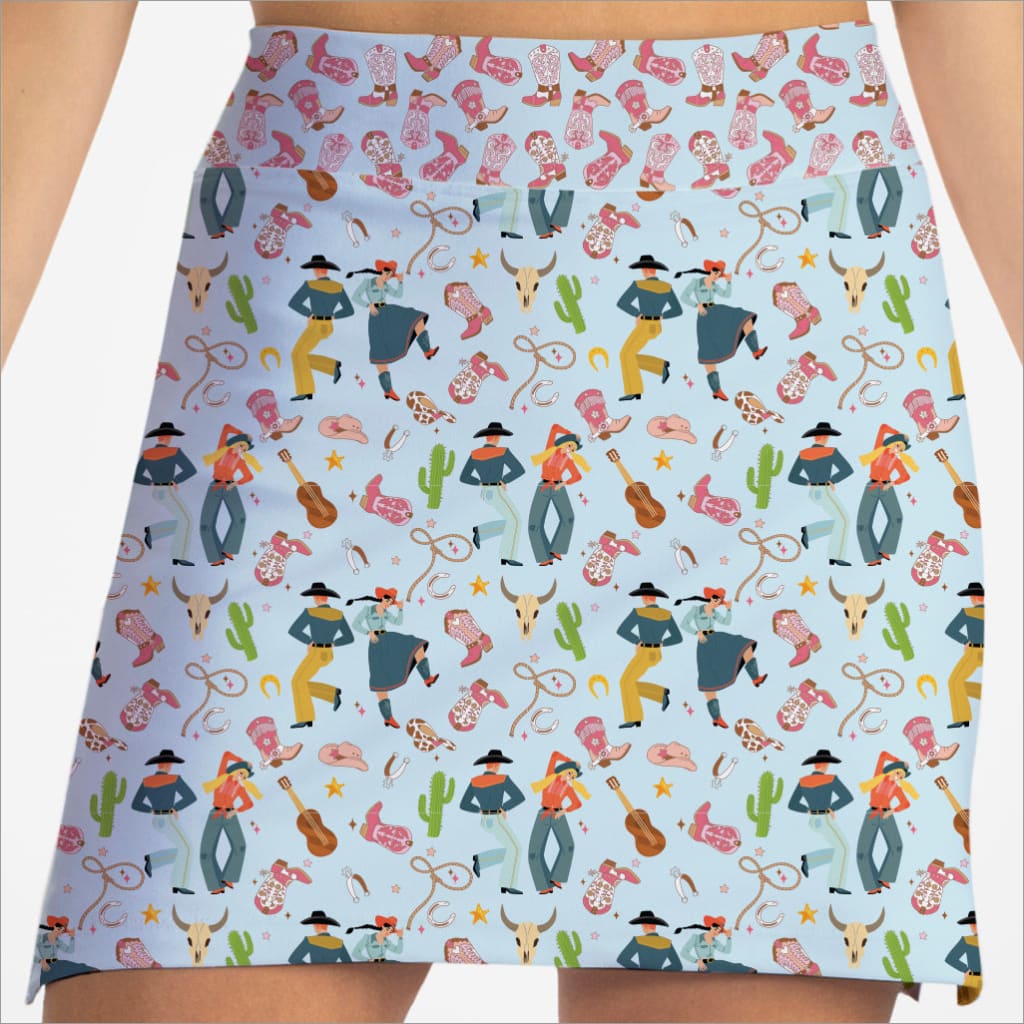 Skirt with colorful pattern of cowboys, horses, and western elements on a light blue background.