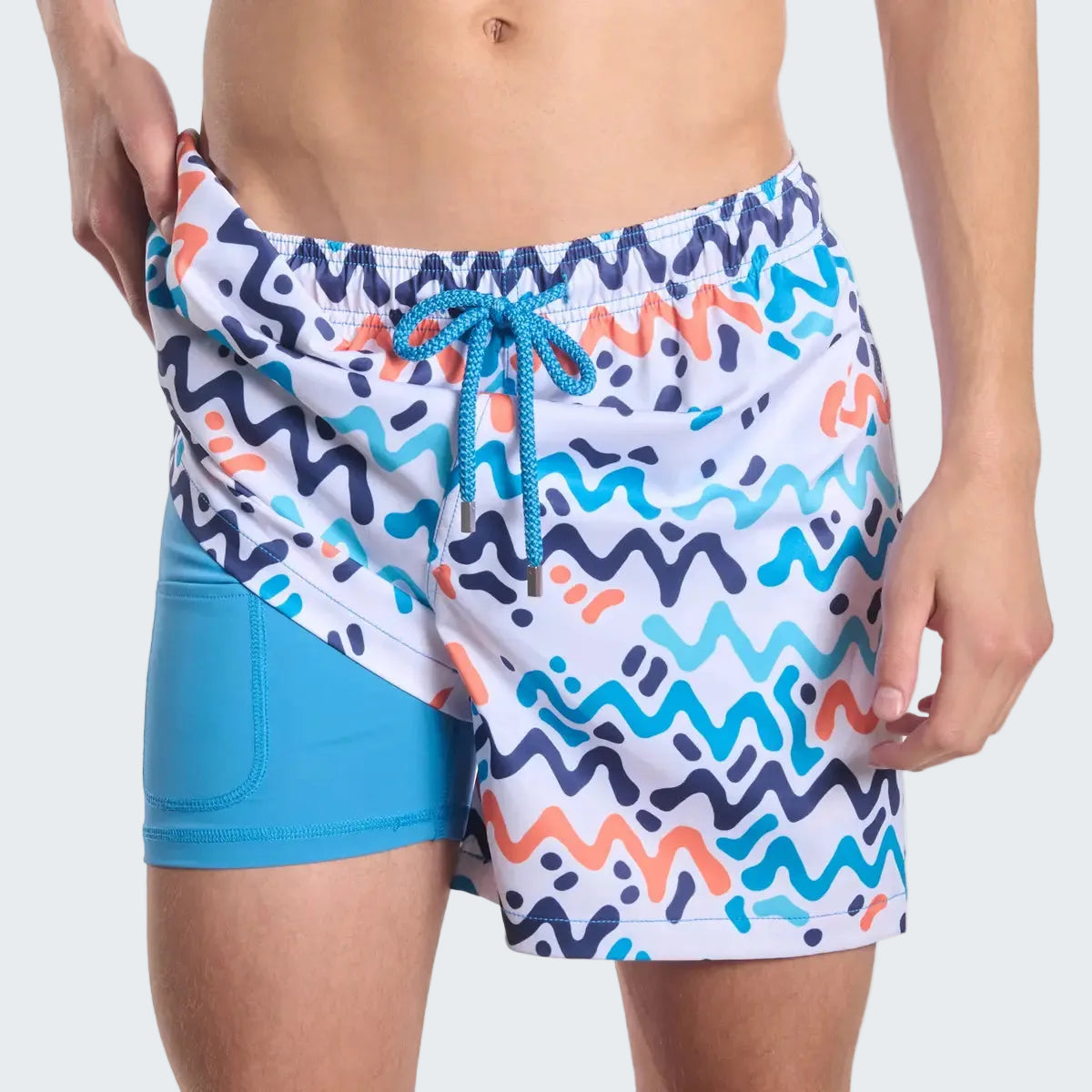 Colorful wavy patterned swim shorts with a blue drawstring on a white background