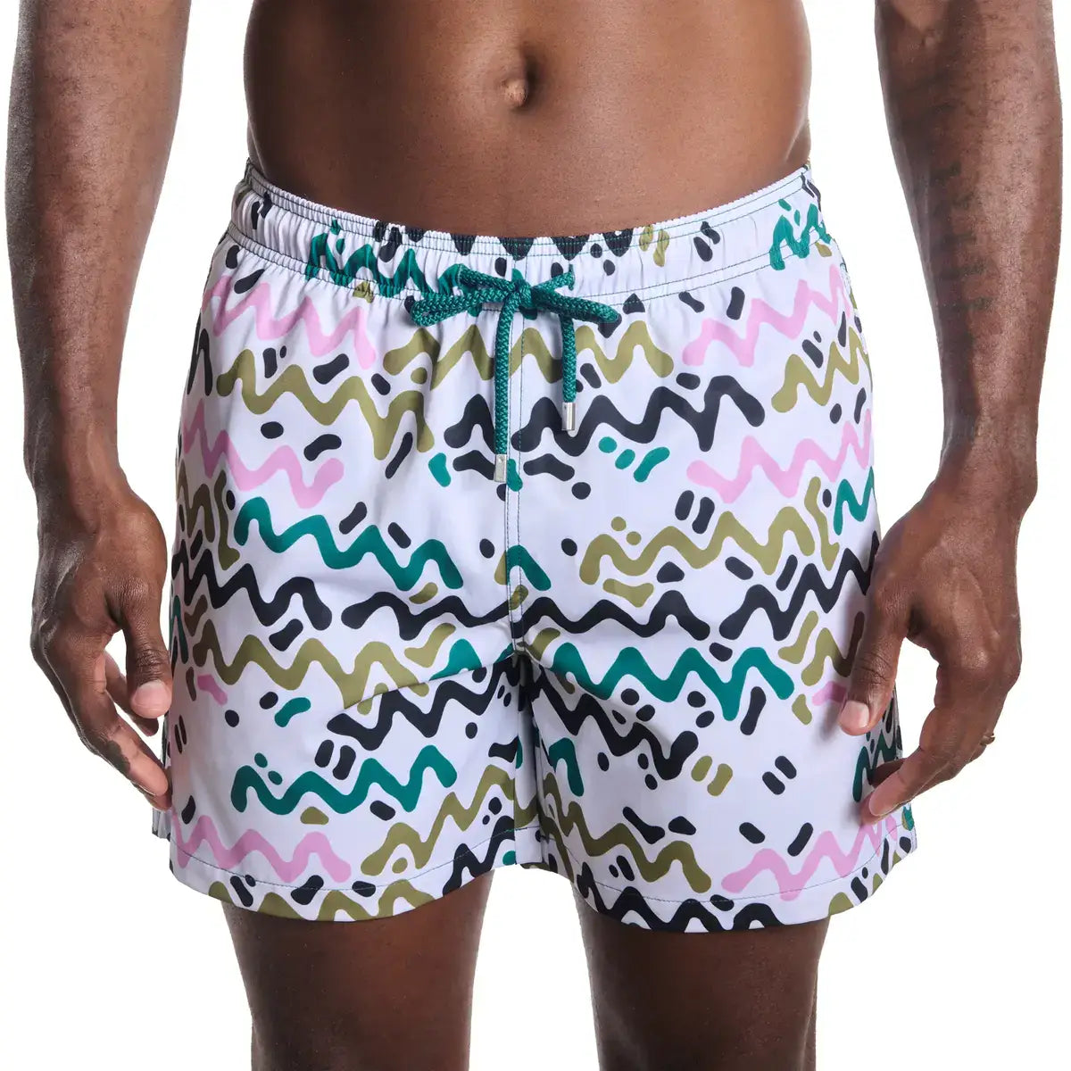 Multicolored patterned swim shorts on a white background