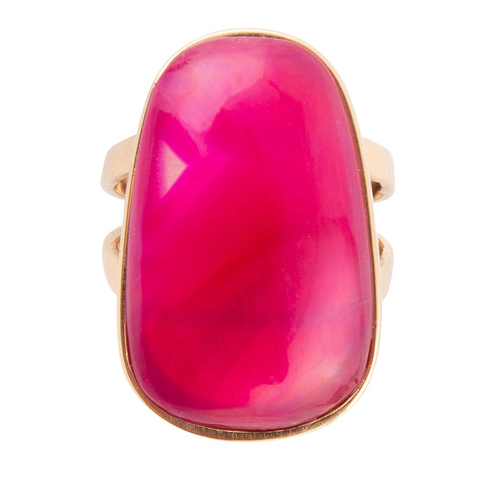 Ring with a pink stone and gold band on a white background