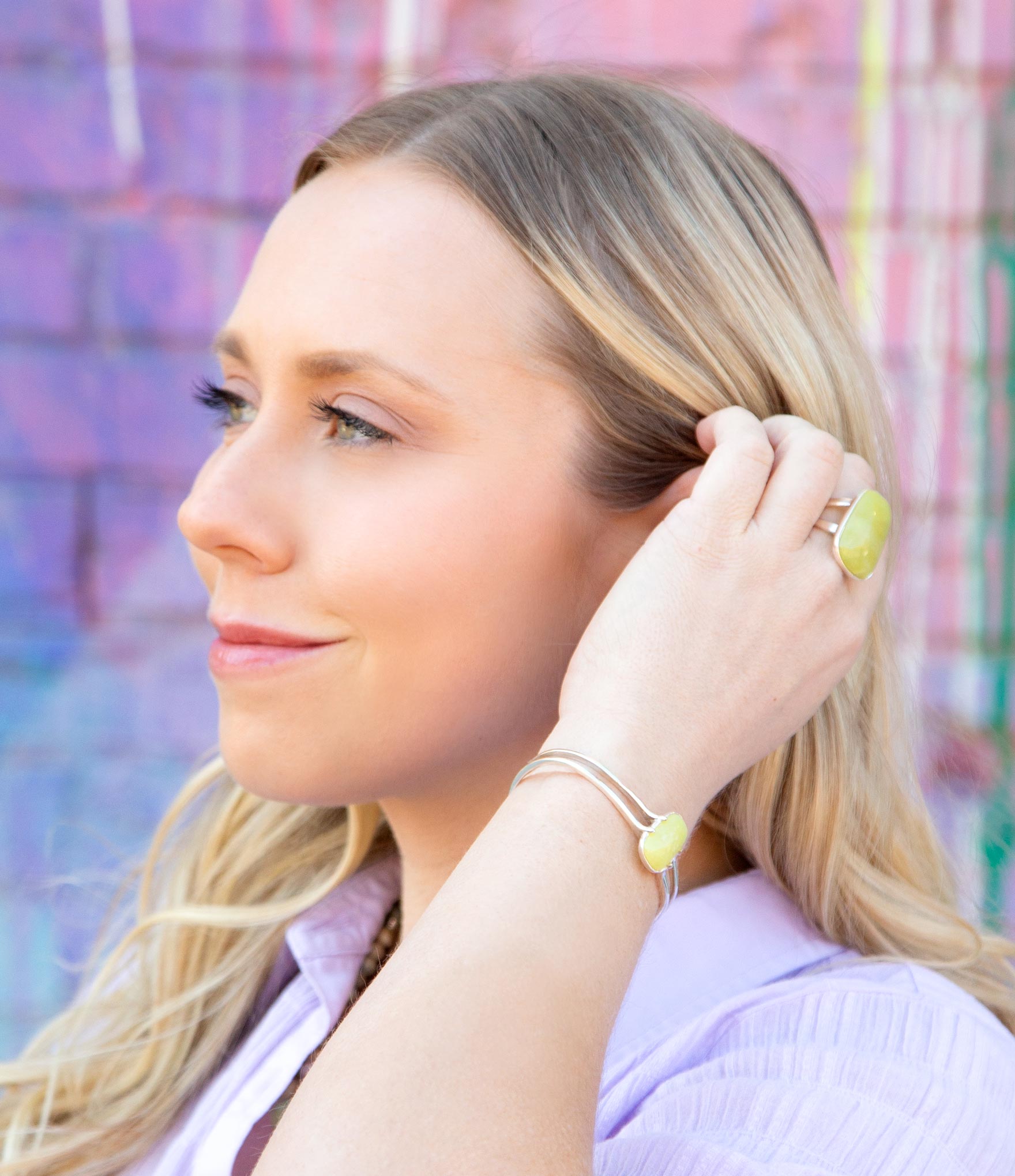 Woman wearing colorful earrings against a multicolored background