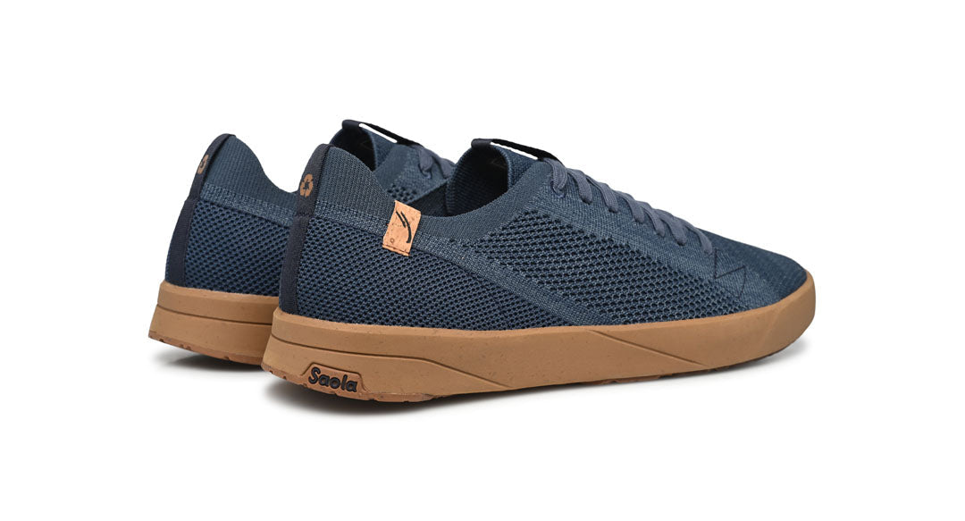 Blue sneakers with brown soles on a white background