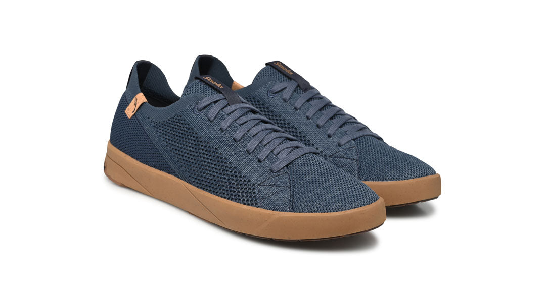 Blue sneakers with brown soles on a white background