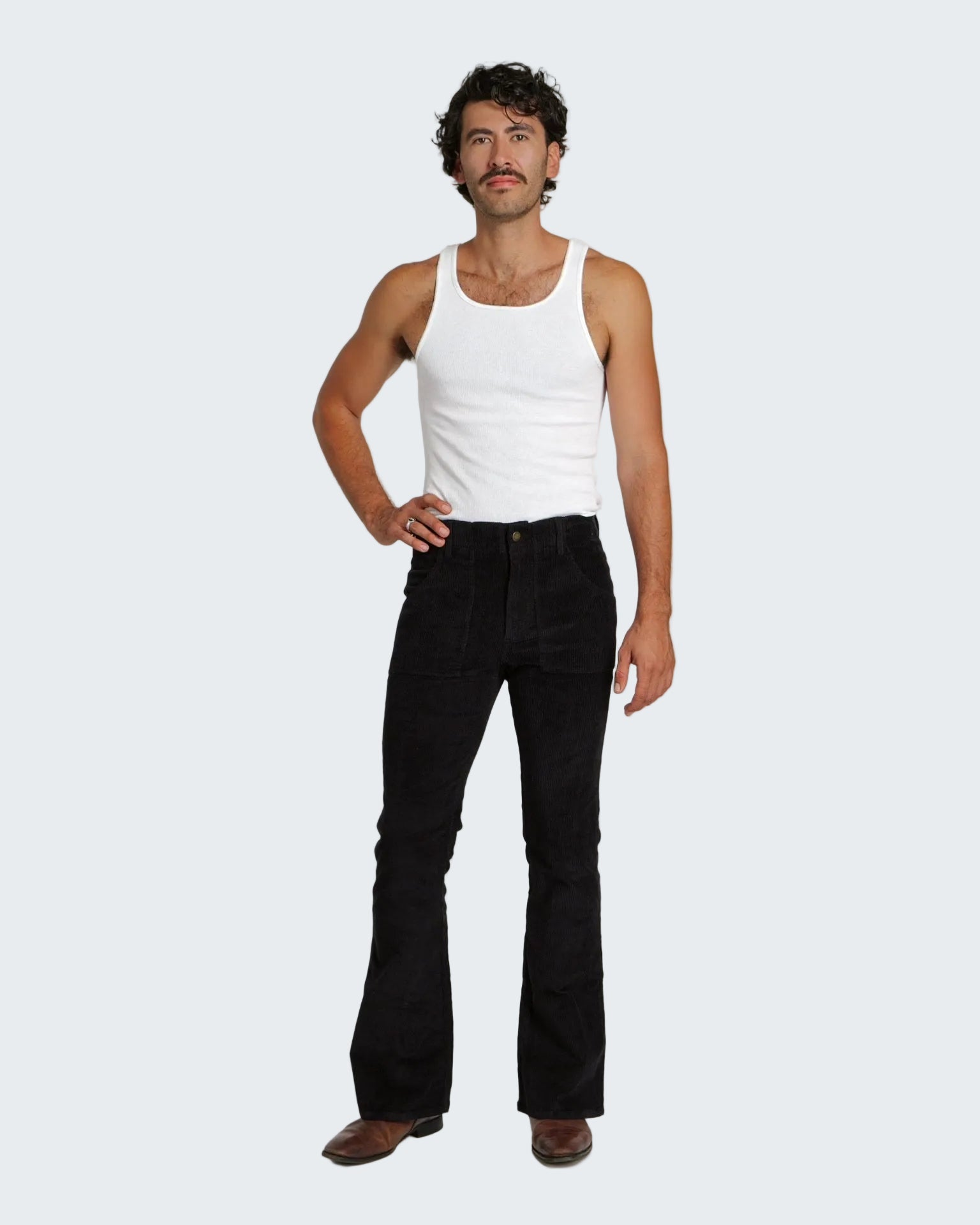 Man wearing a white tank top and black bell-bottom pants on a white background