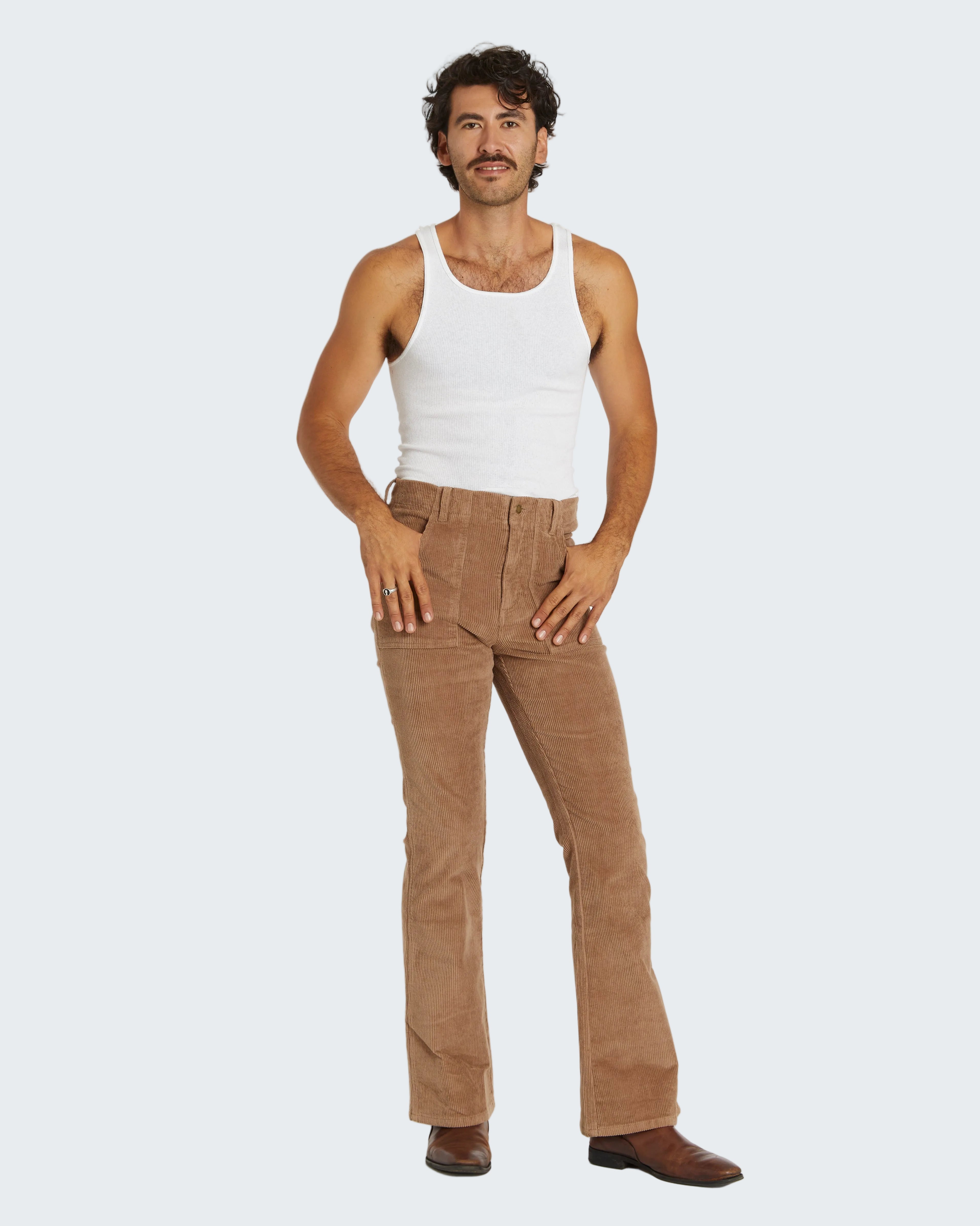 Man wearing a white tank top and brown pants on a white background