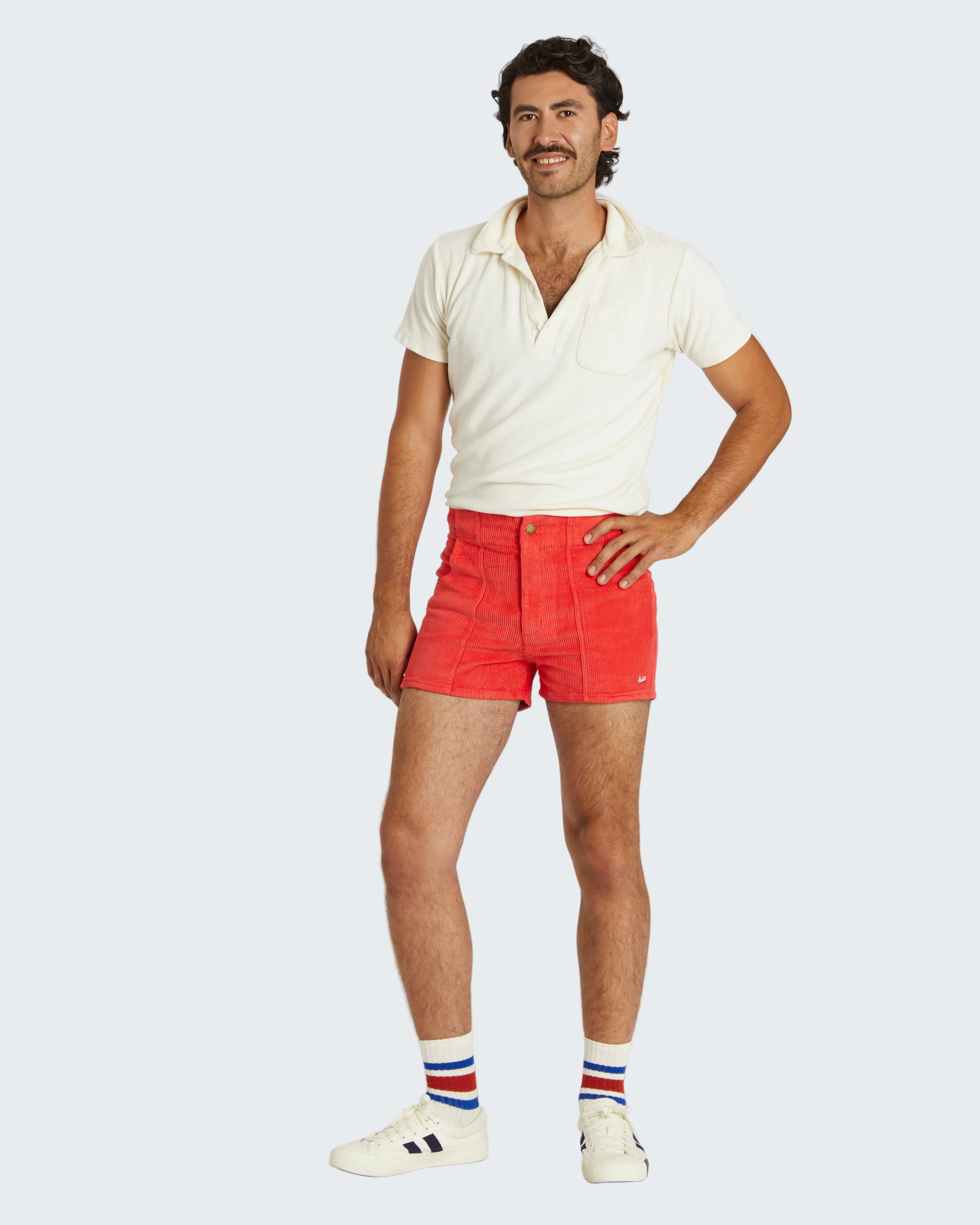 Man wearing a white shirt and red shorts on a white background