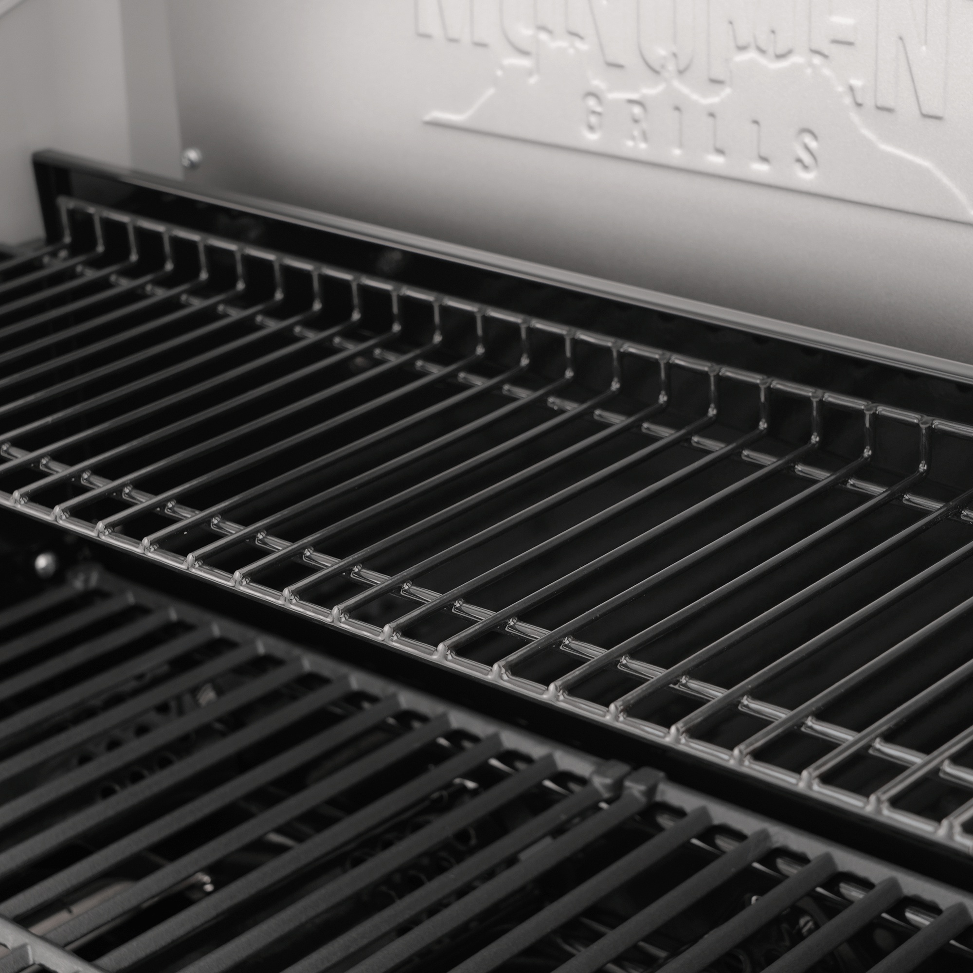Close-up of a grill with 'Highland Park Grills' branding in the background.