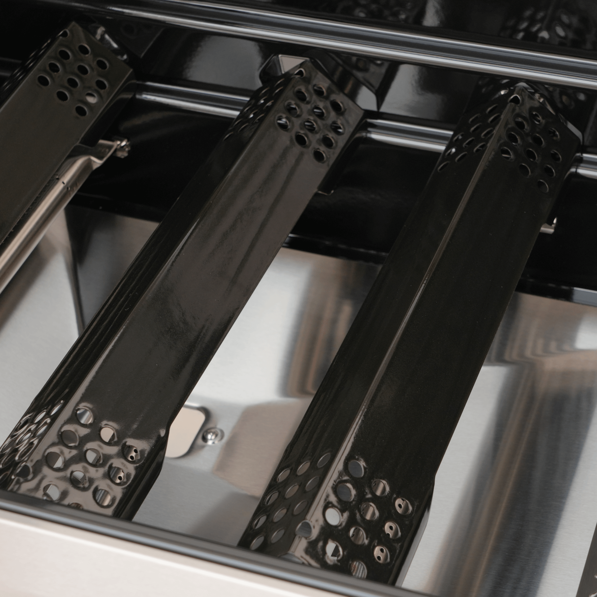 Close-up of black metal grates inside a grill