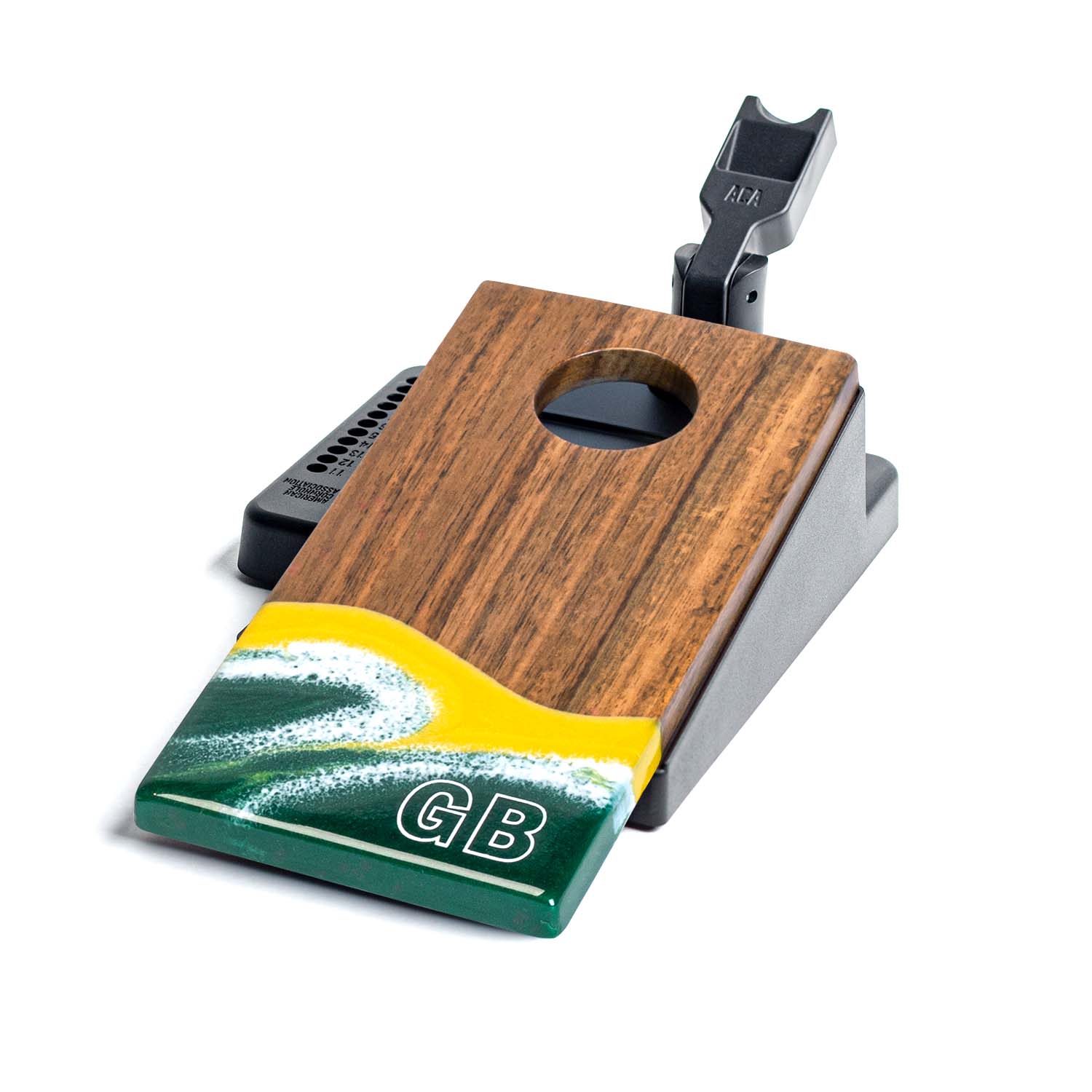Wooden and metal device with a green and yellow base on a white background