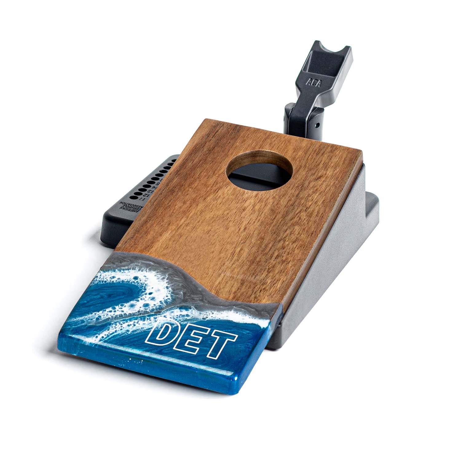 Wooden and metal device with blue wave design and 'DET' branding on a white background