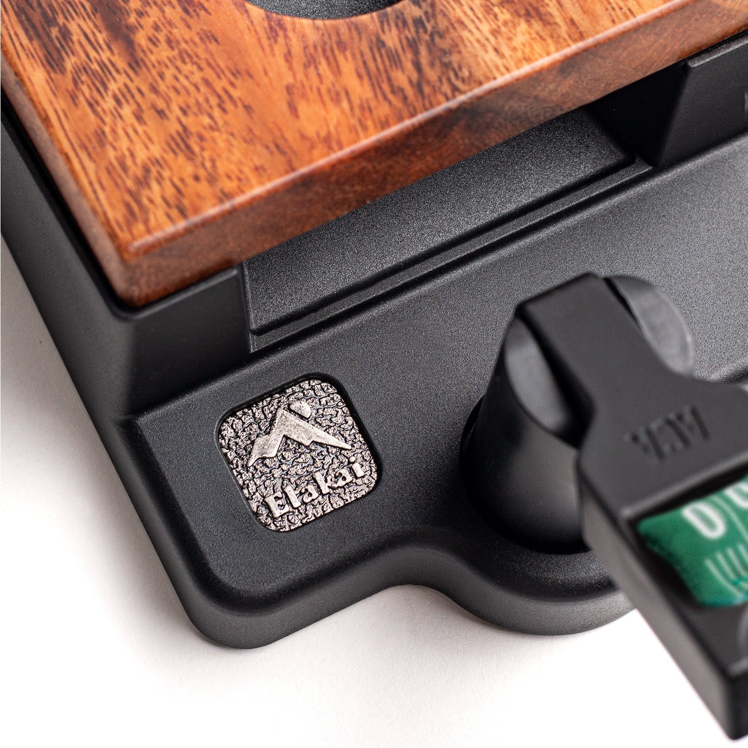 Close-up of a wooden product with a black base and a brand logo on a white background