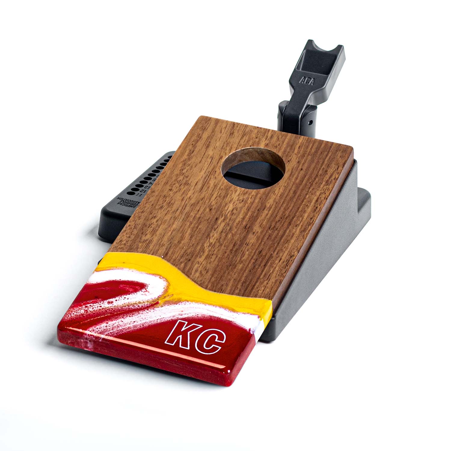 Wooden and red device with 'KC' branding on a white background
