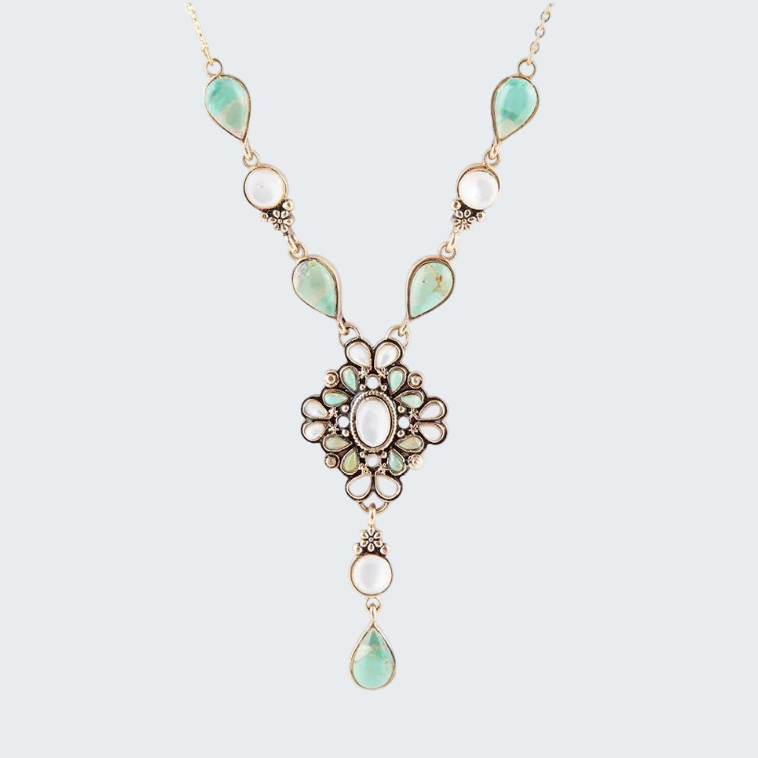 Necklace with green teardrop-shaped stones and gold accents on a white background