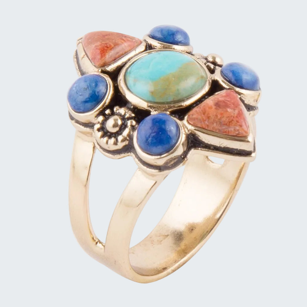 Gold ring with colorful gemstones on a white background