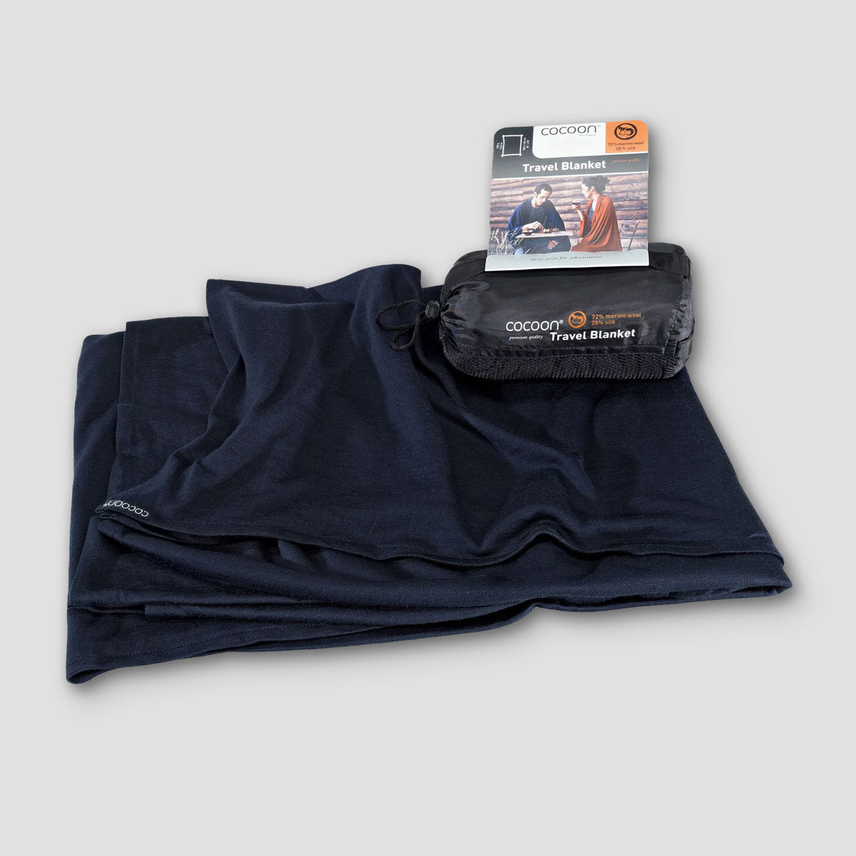 Black travel blanket with packaging on a light gray background