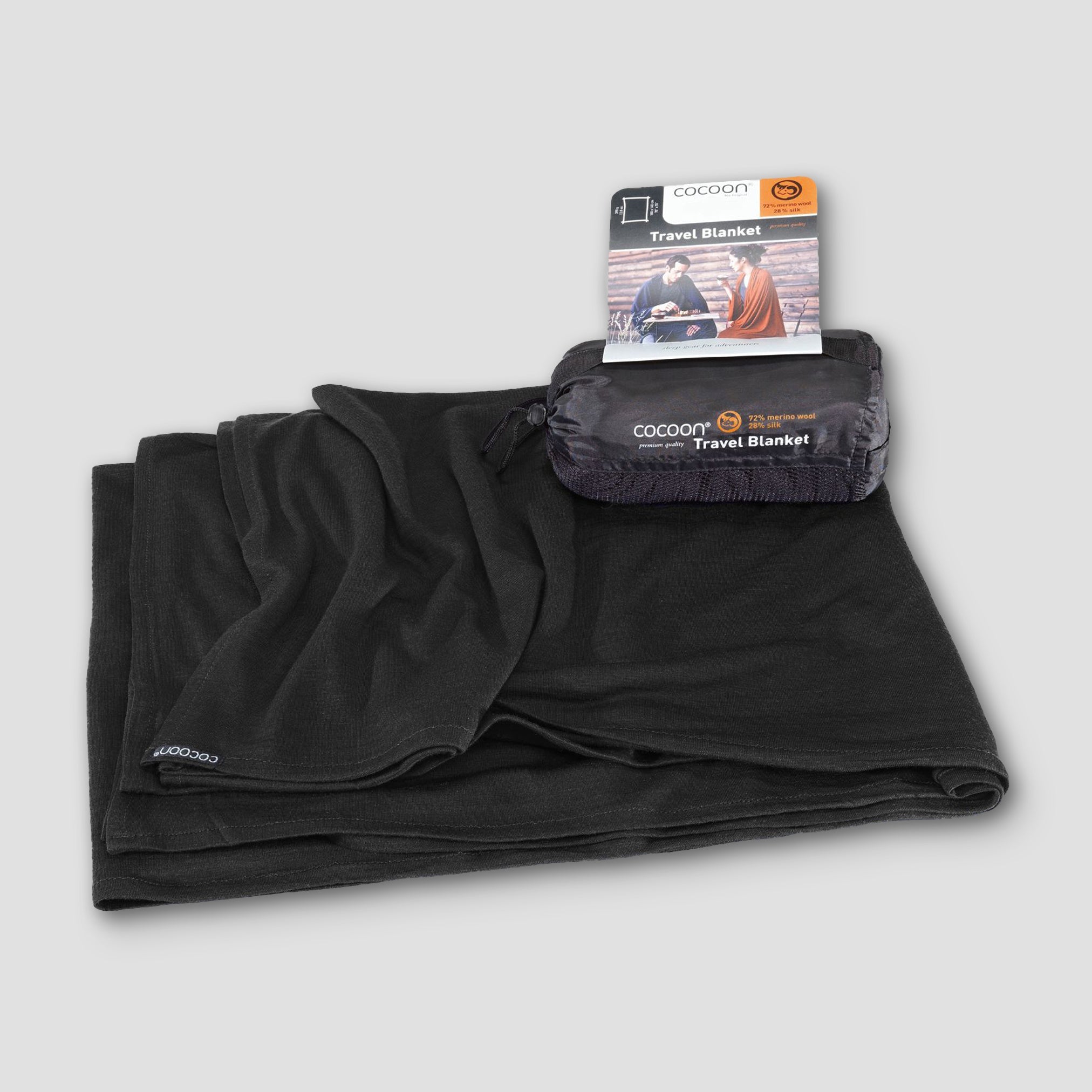 Black travel blanket with packaging on a light gray background