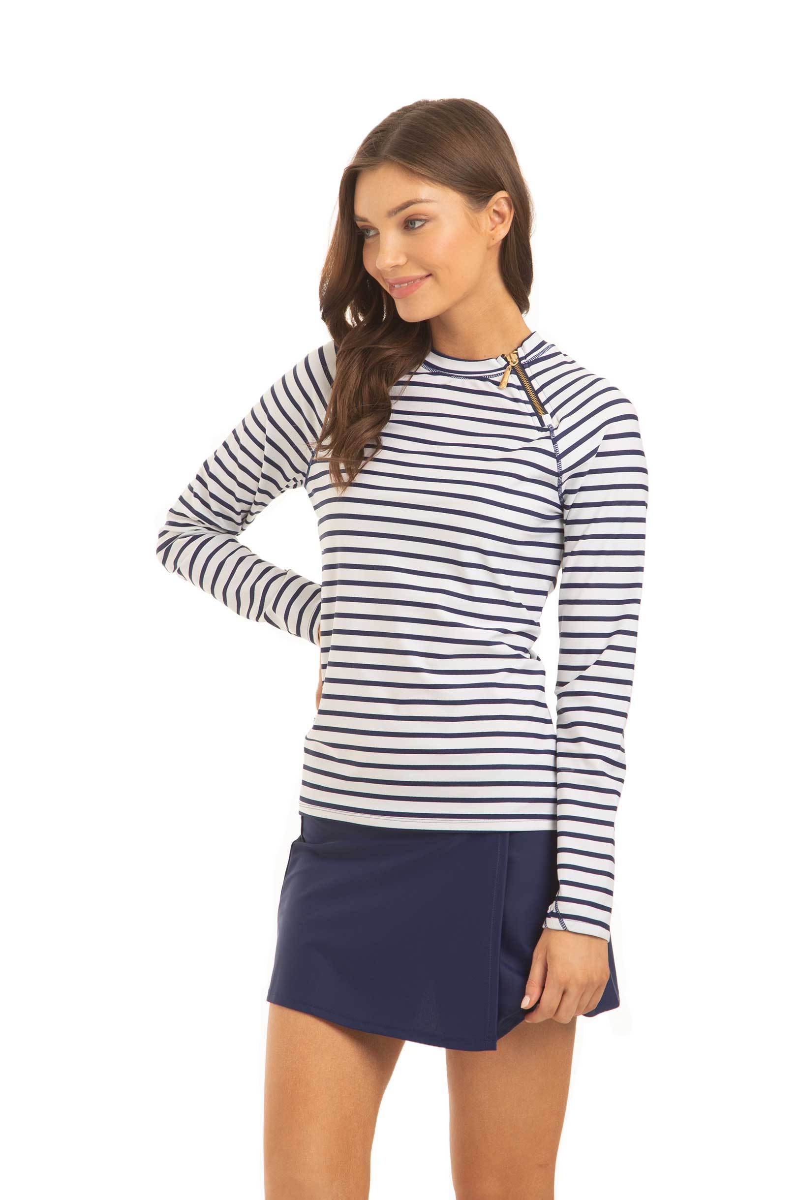 Woman wearing a striped long-sleeve shirt and navy skirt on a white background