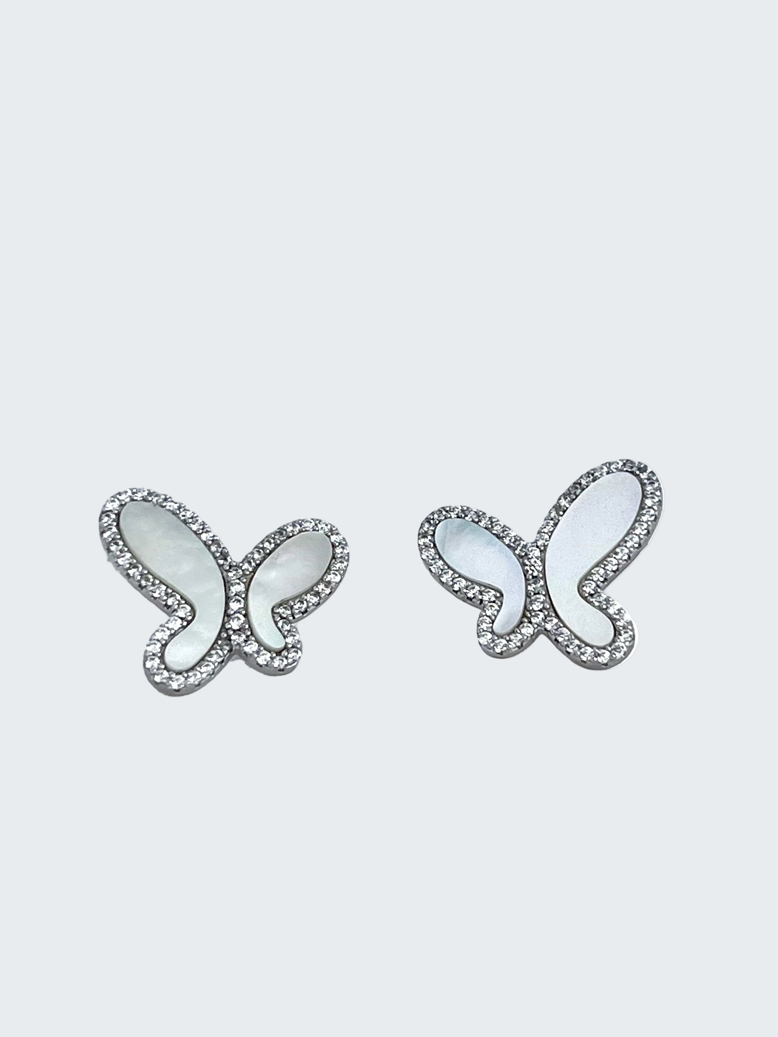Butterfly-shaped earrings with gemstones on a white background