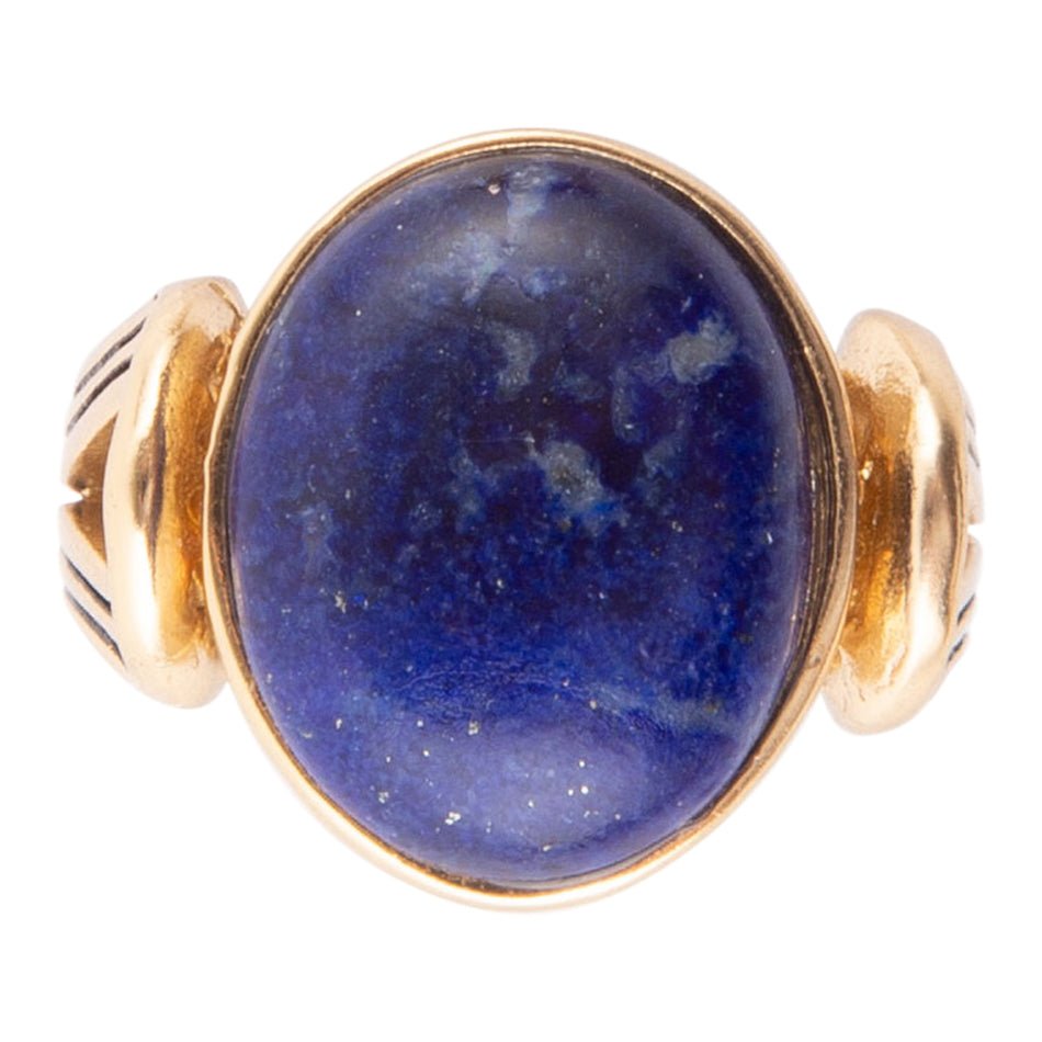 Gold ring with a blue stone on a white background