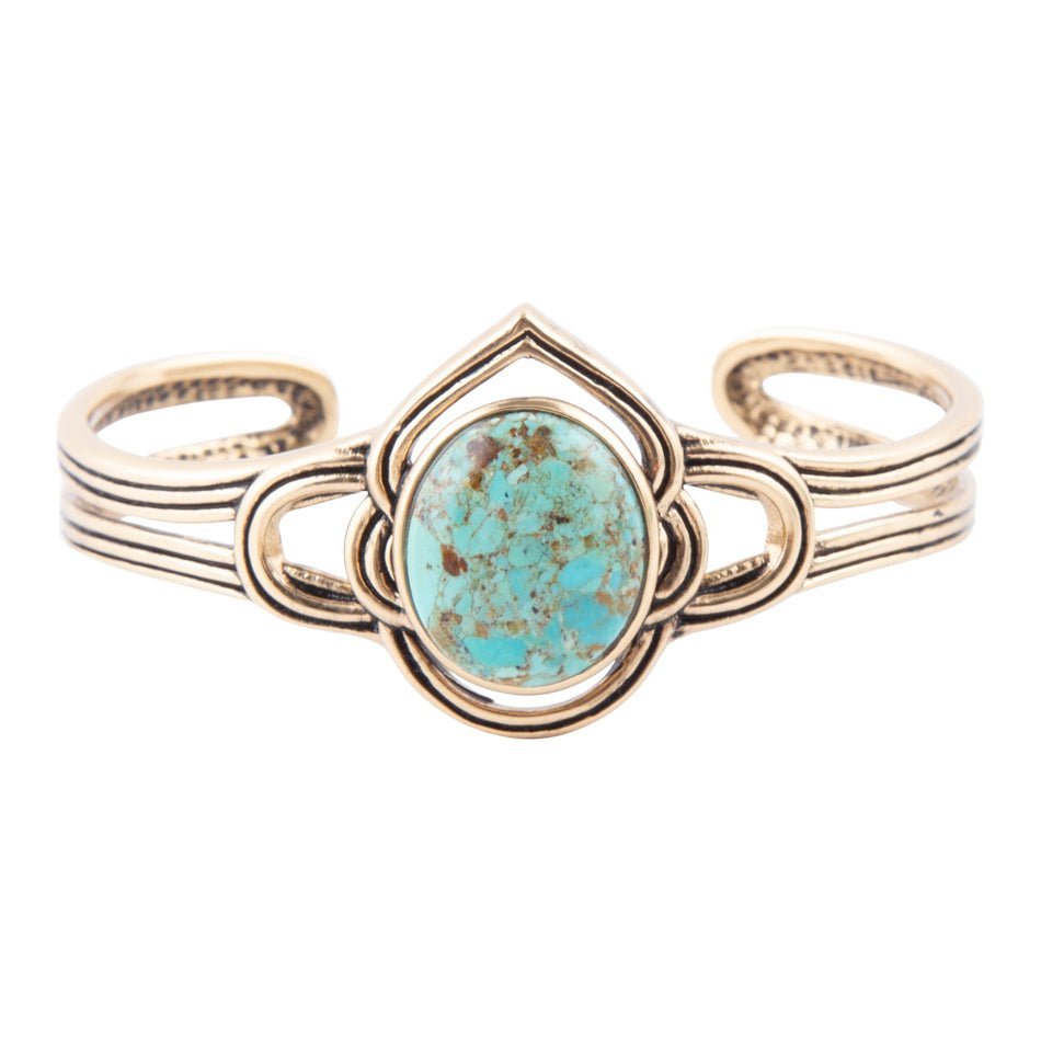 Gold bracelet with a turquoise stone on a white background