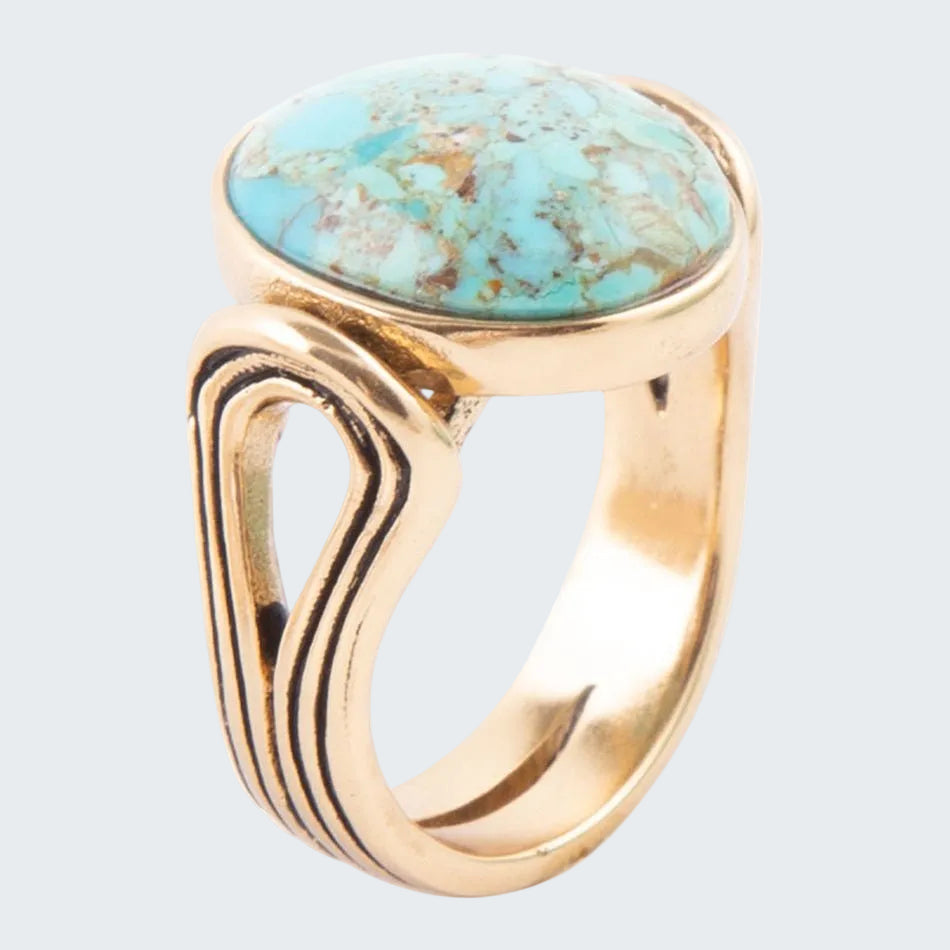 Gold ring with a turquoise stone on a white background
