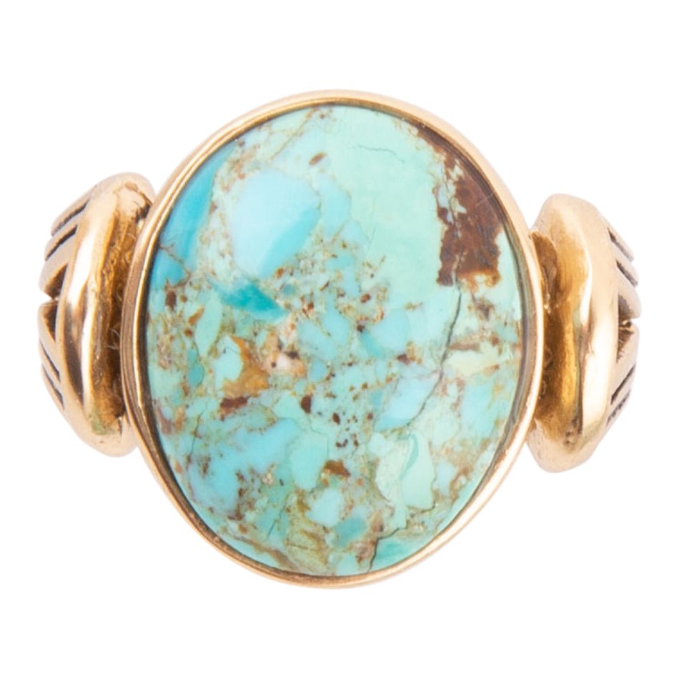 Turquoise stone ring with gold band on a white background