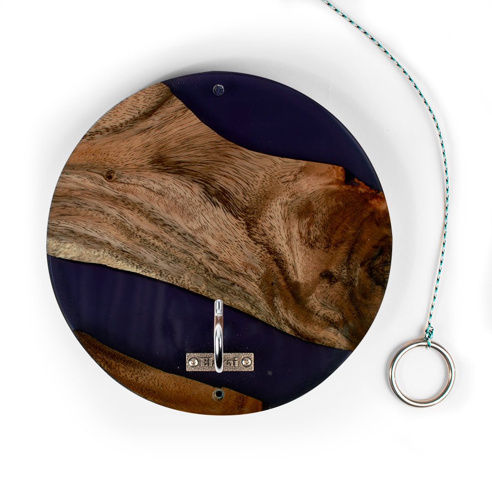 Round wall hook with a natural wood and dark blue resin design, featuring a silver metal ring at the bottom and a hanging string with a metal ring on a white background.