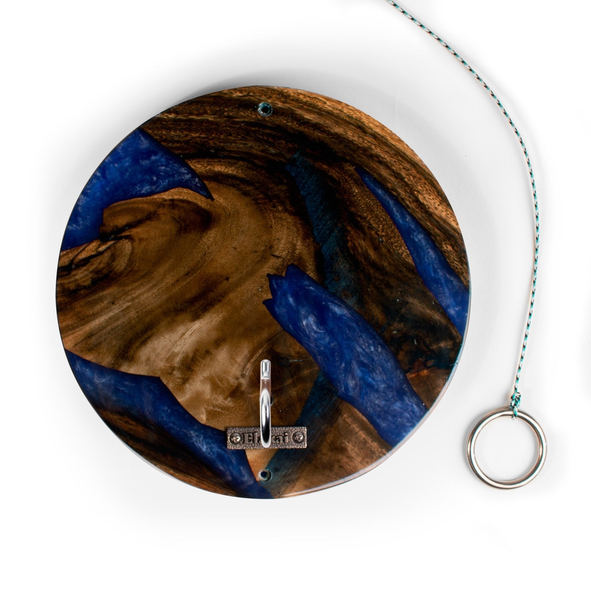 A round decorative wall hook featuring a swirling wood grain and blue resin pattern, with a silver metal ring hanging from the side and a thin blue cord extending upward, shown on a white background.