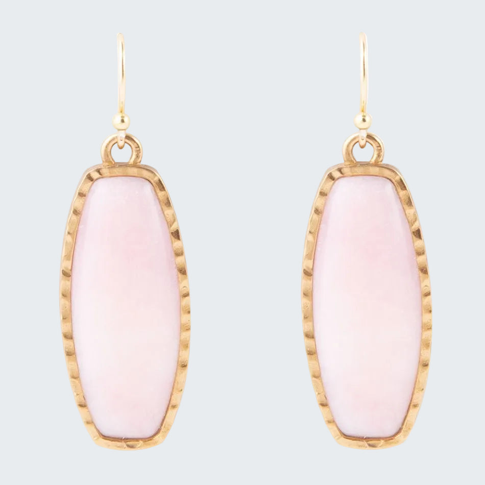 Pink earrings with gold frames on a white background