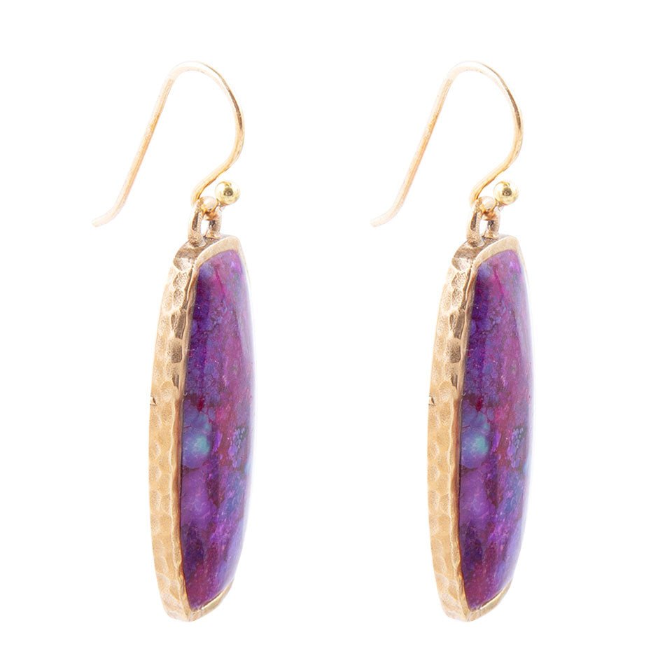 Purple earrings with gold accents on a white background