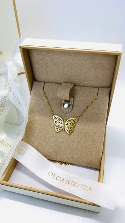 Gold butterfly necklace in a branded box with a pearl pendant