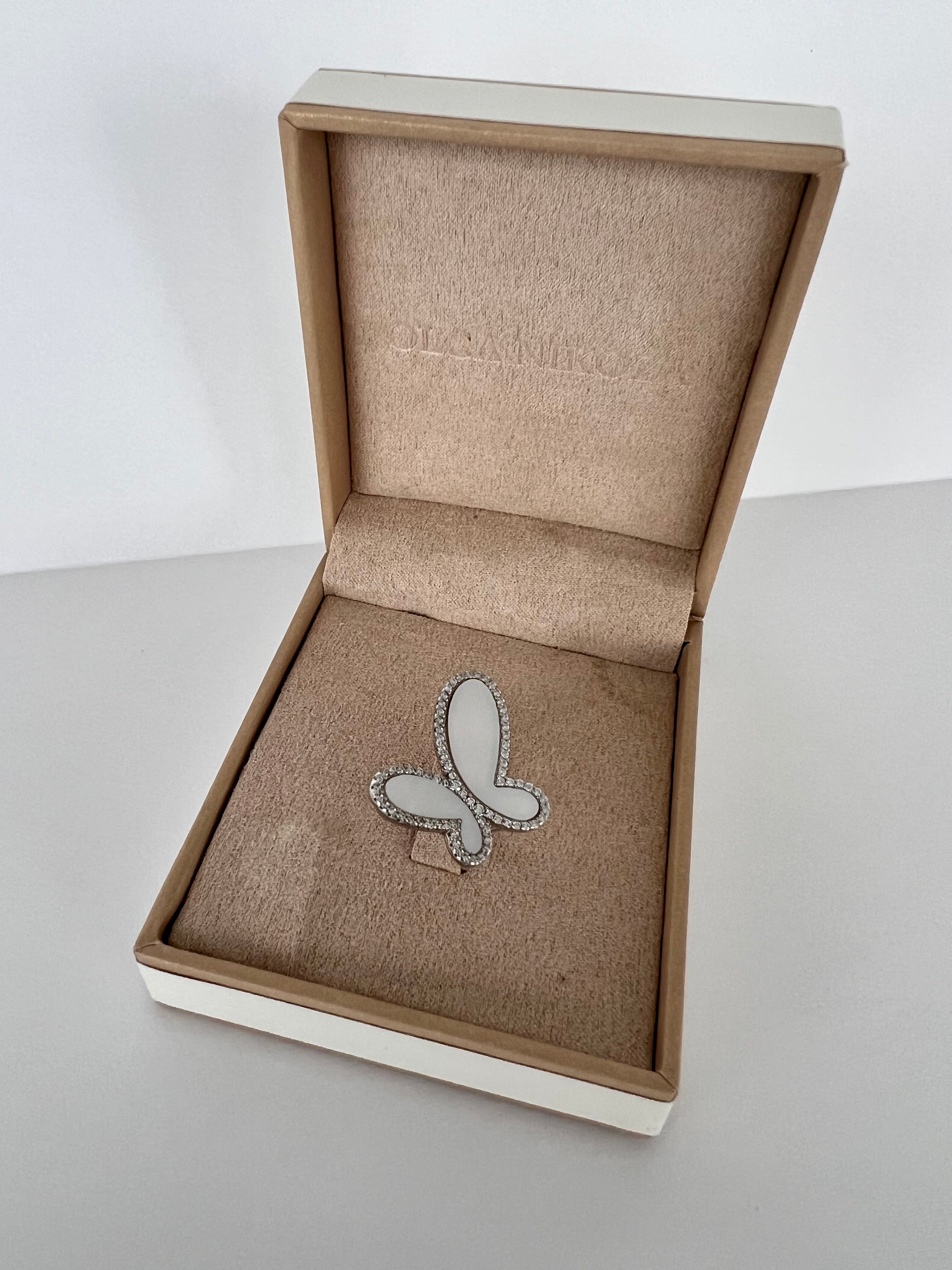 Butterfly brooch in a branded jewelry box on a light surface